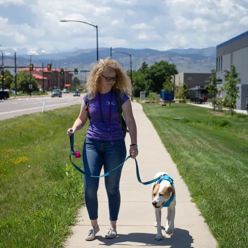 Staff walking with dog at Bowhaus in Boulder, CO